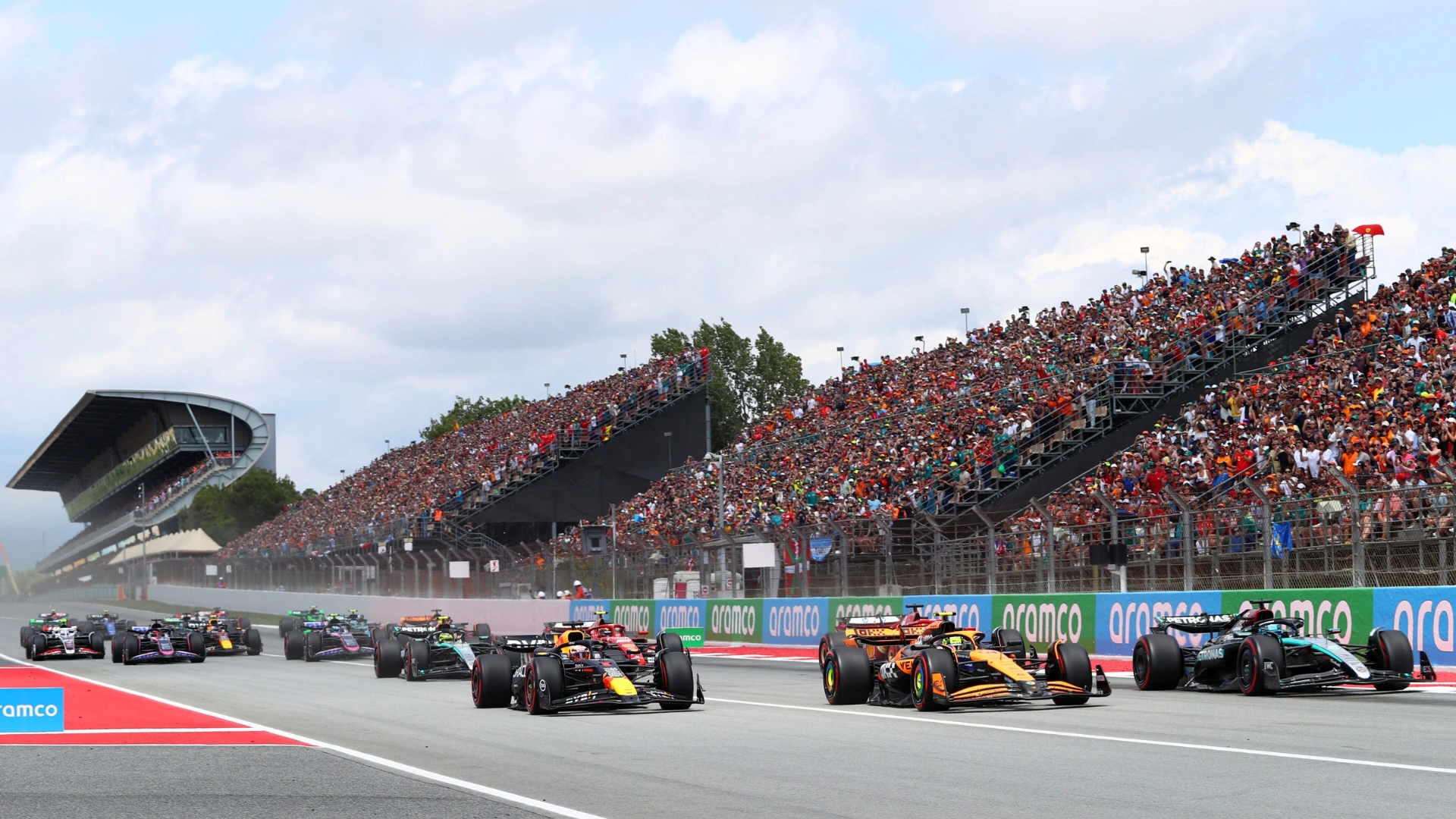 F1 cars approach Turn 1 of the Spanish GP
