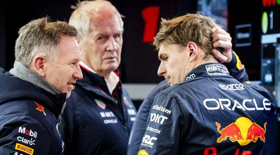 Max Verstappen, Christian Horner, and Helmut Marko talk during an F1 race